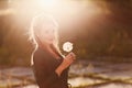 Beautiful woman with big Mature dandelion in hands Royalty Free Stock Photo
