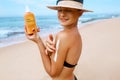 Beautiful Woman in Bikini Applying Sun Cream on Tanned Shoulder. Sun Protection. Skin and Body Care. Girl Using Sunscreen to Skin. Royalty Free Stock Photo