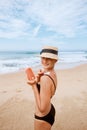 Beautiful Woman in Bikini Applying Sun Cream on Tanned Shoulder. Sun Protection. Skin and Body Care. Girl Using Sunscreen to Skin. Royalty Free Stock Photo