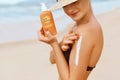 Beautiful Woman in Bikini Applying Sun Cream on Tanned  Shoulder. Sun Protection. Skin and Body Care. Girl Using Sunscreen to Skin Royalty Free Stock Photo