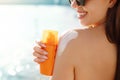 Beautiful Woman in Bikini Applying Sun Cream on Tanned Shoulder. Sun Protection. Skin and Body Care. Girl Using Sunscreen to Skin Royalty Free Stock Photo