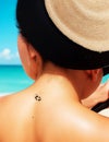 Beautiful woman in bikini applying sun cream on tanned shoulder sun protection Generated by AI