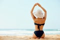 Beautiful woman in bikini applying sun cream on tanned shoulder. Sun protection. Skin and body care. Royalty Free Stock Photo