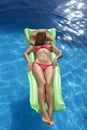 Beautiful woman in bikini and sun hat on face lying relax on fl Royalty Free Stock Photo