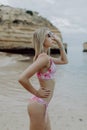 Beautiful woman in bikini on tropical beach. Portrait of happy young woman smiling at sea. Blonde tanned girl in swimwear enjoying Royalty Free Stock Photo