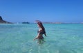 Beautiful happy woman in bikini in turquoise water. Balos beach, Greece Royalty Free Stock Photo