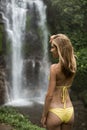 Beautiful woman in bikini and waterfall. Royalty Free Stock Photo