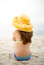 Beautiful woman in bikini and yellow hat relaxing at beach Royalty Free Stock Photo