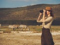 Beautiful woman with binoculars at savanna in Kenya Royalty Free Stock Photo