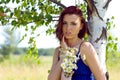 Beautiful woman at the birch. Summer meadow Royalty Free Stock Photo