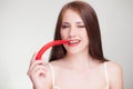 Beautiful woman biting chili pepper Royalty Free Stock Photo