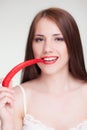 Beautiful woman biting chili pepper Royalty Free Stock Photo