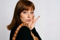 Beautiful woman in black bodywear and snake. Ginger model girl with fashion perfect make up Royalty Free Stock Photo