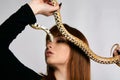 Beautiful woman in black bodywear and snake. Ginger model girl with fashion perfect make up Royalty Free Stock Photo