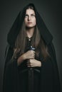 Beautiful woman with black cloak and sword Royalty Free Stock Photo