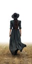 Beautiful woman in black hat and green dress walking in wheat field. Amish woman walking away. Royalty Free Stock Photo