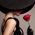 Beautiful woman in black hat and red rose Royalty Free Stock Photo