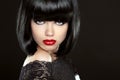 Beautiful Woman With Black Short Hair. Haircut. Hairstyle. Fringe. Professional Makeup. Lady isolated on black background. Royalty Free Stock Photo