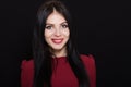 A beautiful woman with black straight hair and blue eyes in a burgundy dress