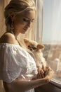 Beautiful woman with blond hair with cute little dog Royalty Free Stock Photo