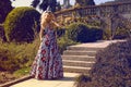 Beautiful woman with blond hair in elegant dress at park Royalty Free Stock Photo