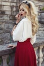 Beautiful woman with blond hair in elegant dress at park Royalty Free Stock Photo