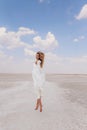 Beautiful woman with blond hair in elegant wedding dress posing in salt lake Royalty Free Stock Photo