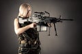 Beautiful woman blonde aiming machine gun Royalty Free Stock Photo