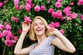 Beautiful woman with blonde hair in garden. summer and spring park nature. rose flower smell. Parfume. natural beauty