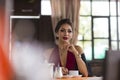 Beautiful woman blonde model in a red jumpsuit fashionable and elegant with a Cup of tea in the restaurant Royalty Free Stock Photo