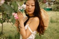 Beautiful Woman With Blooming Sakura Tree In Sunny Day.