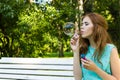 Beautiful woman blowing bubbles in the sun Royalty Free Stock Photo