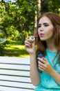 Beautiful woman blowing bubbles in the sun Royalty Free Stock Photo