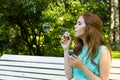 Beautiful woman blowing bubbles in the sun Royalty Free Stock Photo