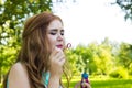 Beautiful woman blowing bubbles in the sun Royalty Free Stock Photo