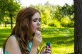 Beautiful woman blowing bubbles in the sun Royalty Free Stock Photo