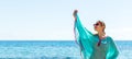 Beautiful woman in blue beach dress is having fun at the seaside. Sea background concept Royalty Free Stock Photo
