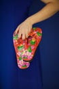 Beautiful woman in blue dress holding flip flop sandals in her hands, like flip flops, sunglasses and beach bag Royalty Free Stock Photo