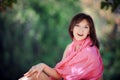 Beautiful woman in a blue dress sitting on a bench in the park Royalty Free Stock Photo