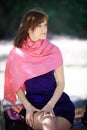 Beautiful woman in a blue dress sitting on a bench in the park Royalty Free Stock Photo