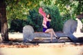 Beautiful woman in a blue dress sitting on a bench in the park Royalty Free Stock Photo