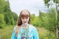 Beautiful woman in blue holds chicory flowers