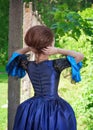 Beautiful woman in blue medieval dress outdoor, back Royalty Free Stock Photo