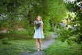 Beautiful woman in a blue summer dress with lilac flowers in a blooming garden. Spring Blossom Royalty Free Stock Photo