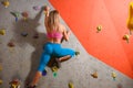 Beautiful Woman Climber Bouldering in the Climbing Gym. Extreme Sport and Indoor Climbing Concept Royalty Free Stock Photo