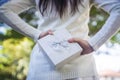 Beautiful woman with a box in her hands behind her back. Royalty Free Stock Photo