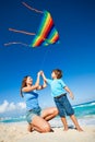 Beautiful woman and boy holding arms with kite Royalty Free Stock Photo