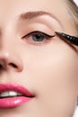 Beautiful woman with bright make up eye with black liner makeup. Fashion arrow shape. Chic evening make-up. Makeup beauty wit Royalty Free Stock Photo