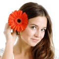 Beautiful woman with a bright red flower Royalty Free Stock Photo