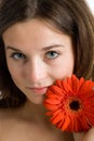 Beautiful woman with a bright red flower Royalty Free Stock Photo